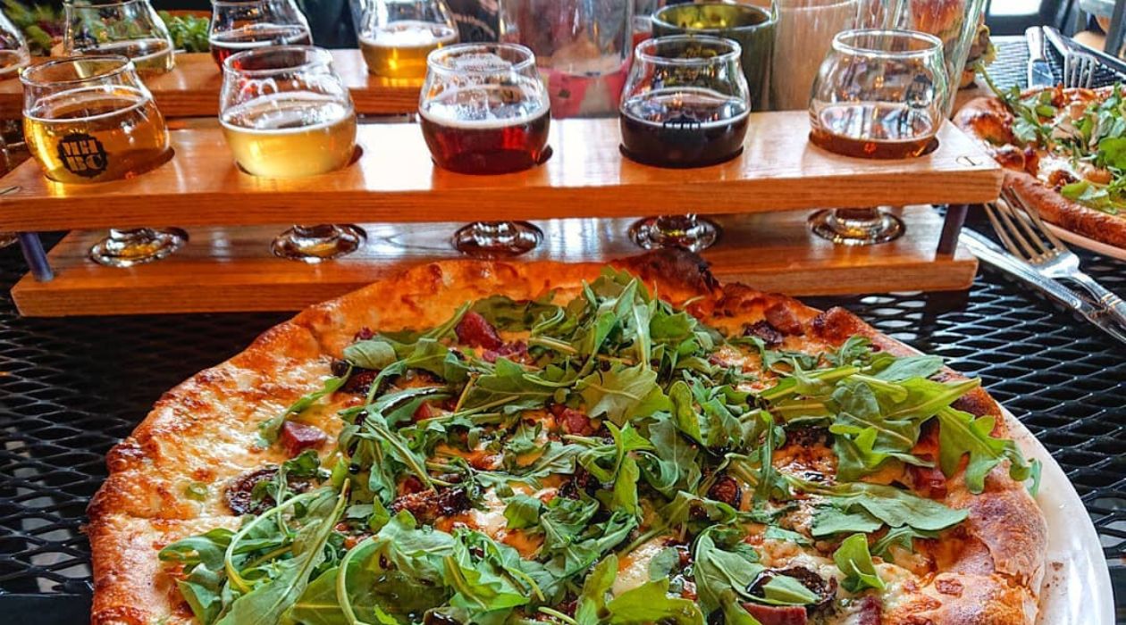 Pizza in front of beer flight at Mill House Brewing Company