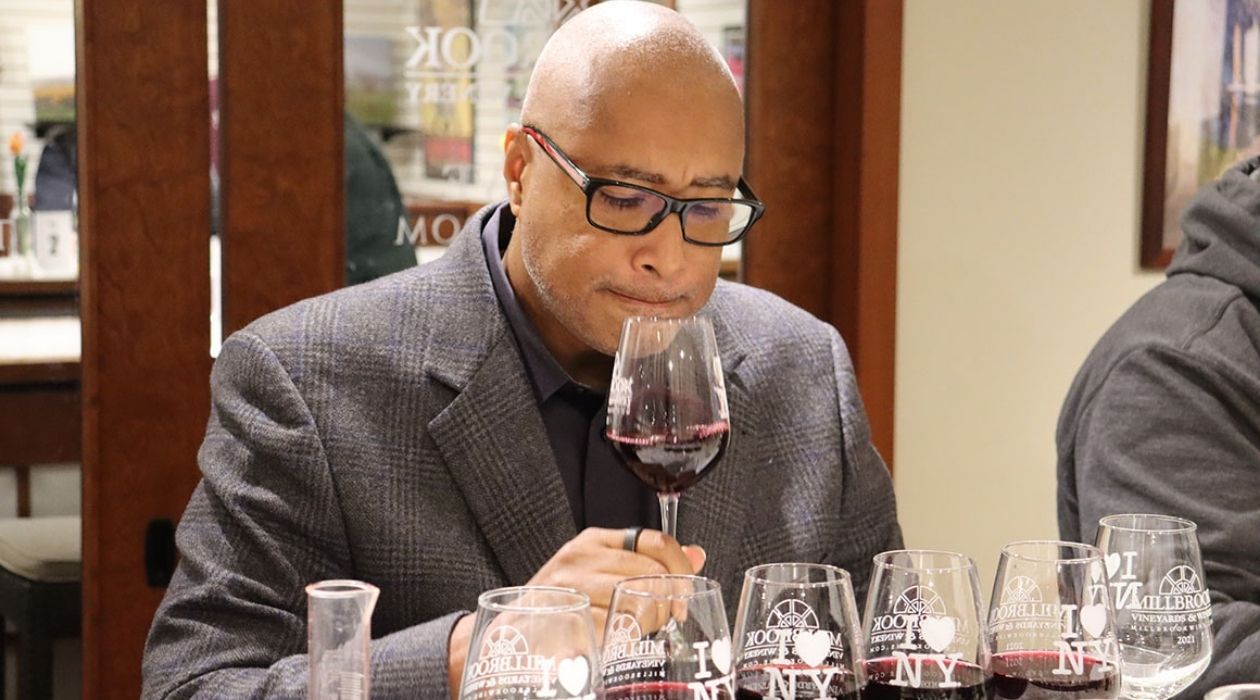 Bernie Williams examines a glass of wine at Millbrook Vineyards and Winery (photo courtesy of Millbrook Vineyards and Winery)