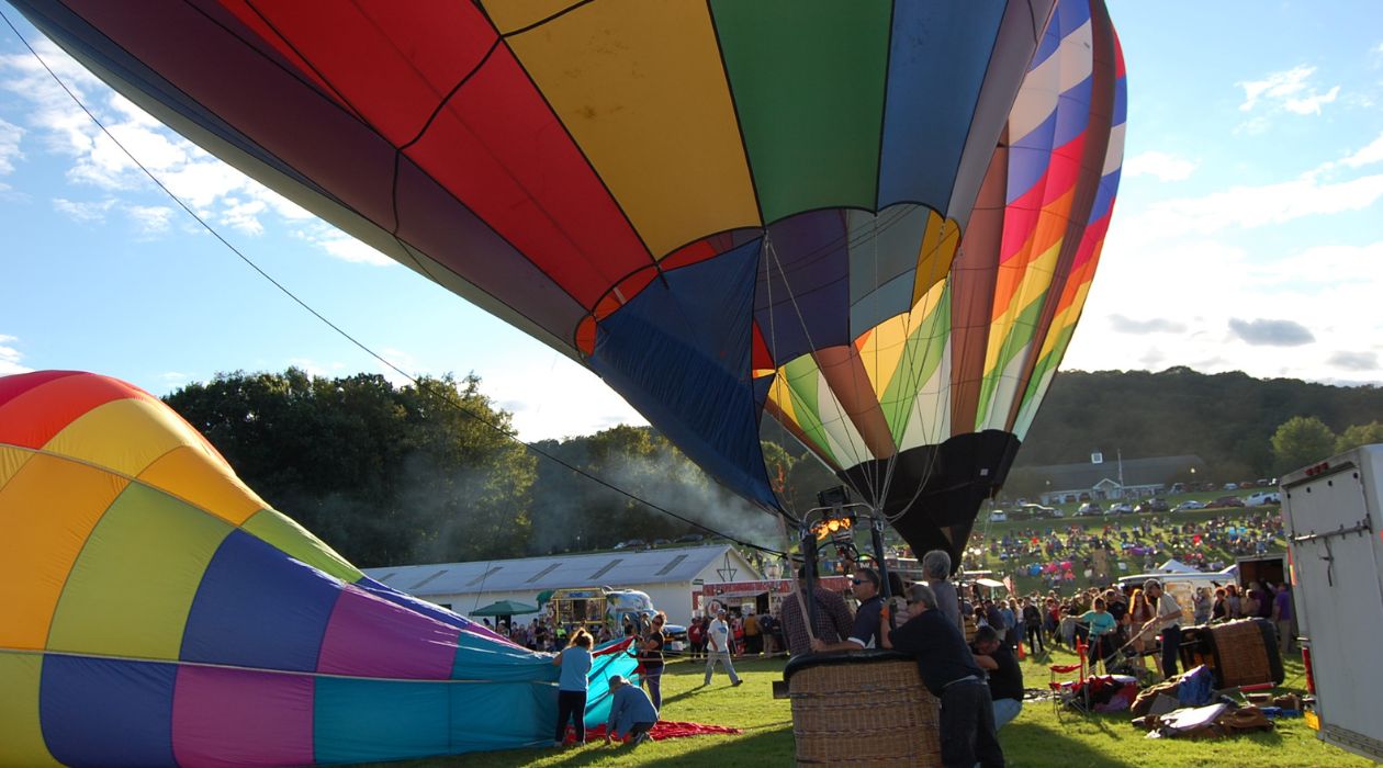 Pilots preparing hot air balloons for flight at Tymor Park
