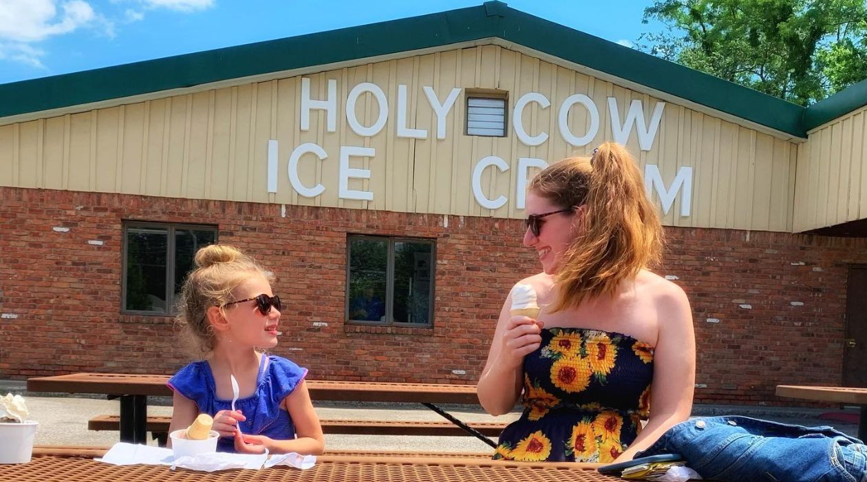 Mother and daughter eating ice cream at picnic table Holy Cow Red Hook