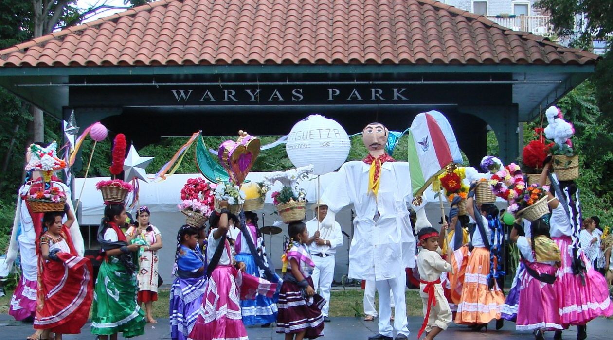Dancers in colorful costumes perform on stage during La Guelaguetza at Waryas Park in Poughkeepsie.