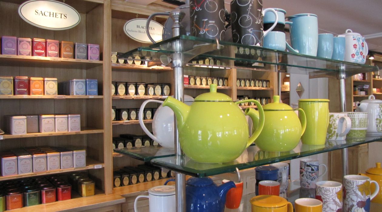 Tea room filled with shelves of boxed teas and tea pots