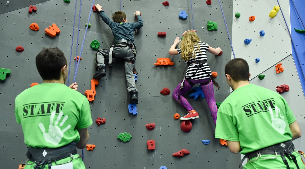 Kids climbing a rock wall at The Gravity Vault, Poughkeepsie
