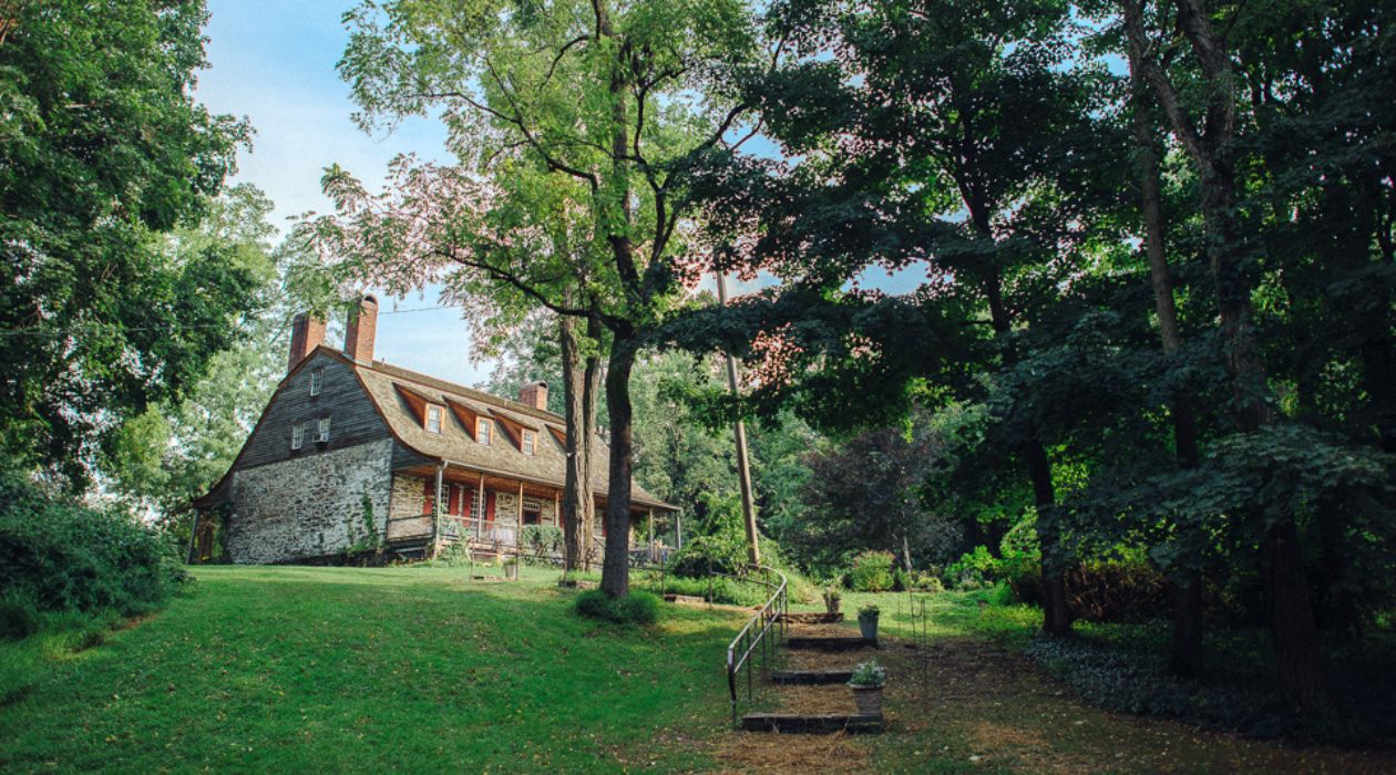 Mount Gulian Historic Site, Beacon. The riverfront homestead originally built in 1730 by the Verplanck family is a two story home. Photographed from the historic Dutch barn looking up the grassy hill at the back of the house.