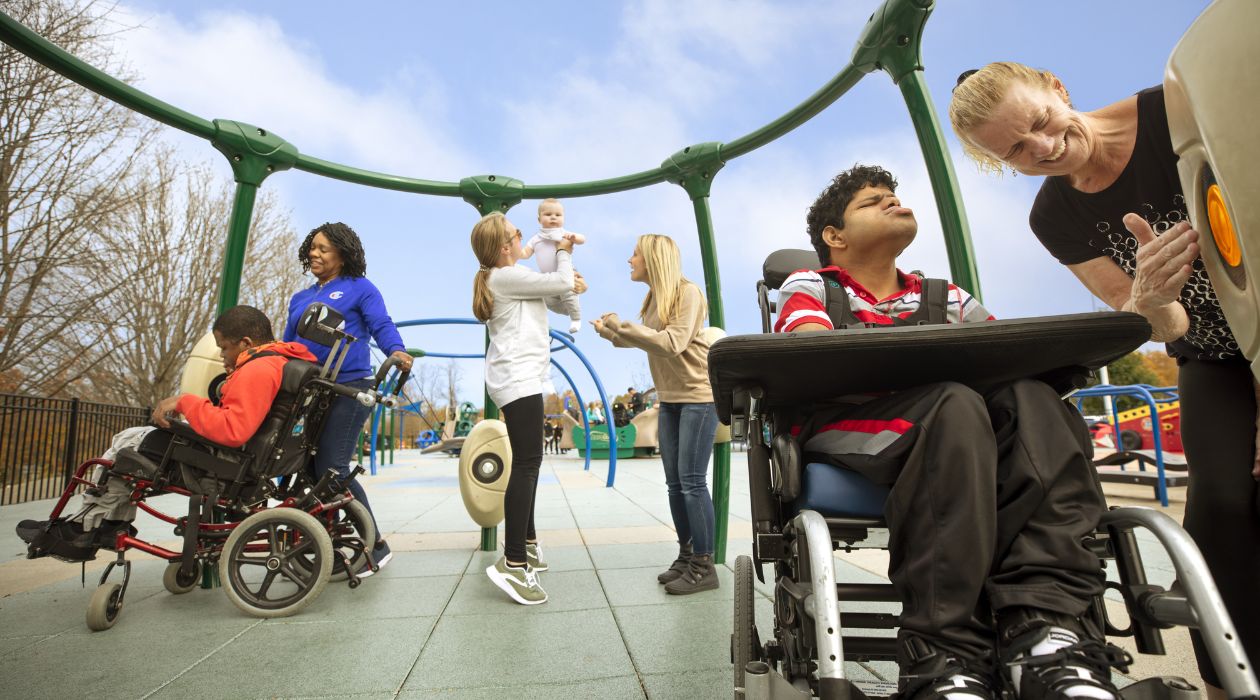 Children of various abilities play at a wheelchair accessible playground