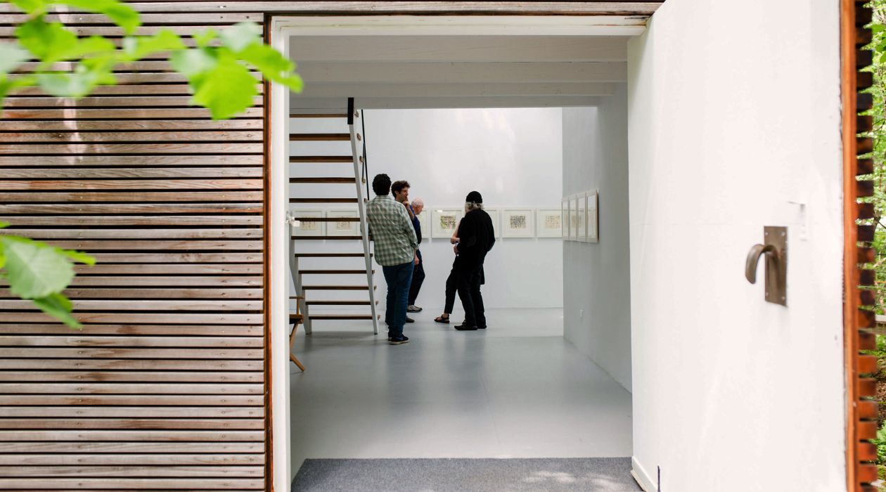 Open door into small modern art gallery
