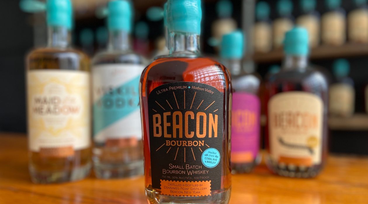 Bottle of Beacon Bourbon on a wooden bar in taproom